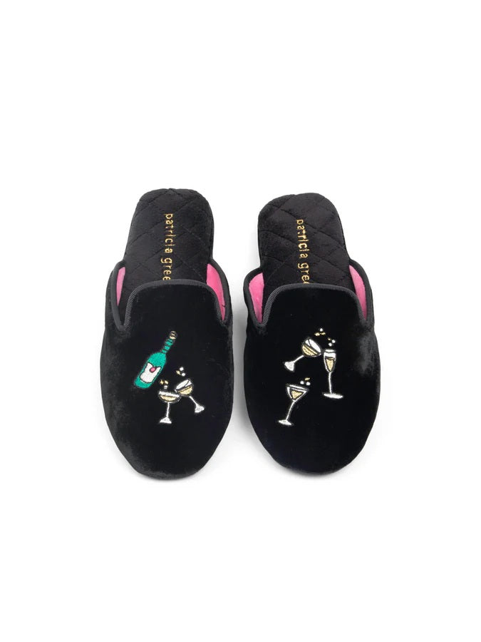 Pair of black slippers with champagne glass designs on ablack background. Great slipper to wear toasting by thefire place