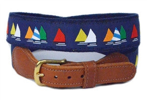 Men's nautical sailboat ribbon belt comes with multi colored sails on a navy ground and is completed with navy cotton webbing, leather tabs and a brass buckle. Sizes 30-44