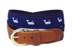                                                                                                                                                                                                                                                                                Classic white whales on a navy ribbon background is so classic. This ageless piece of the preppy past is finished on navy webbing with leather tabs and a brass buckle.                                                                   