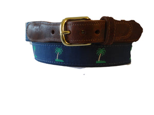 Mens Custom Canvas ribbon Palm Tree belt has colorful green palms on a nvy ribbon background THe ribbon is stitched to navy webbing with leather tabs and a brass buckle. Sizes: 30-44