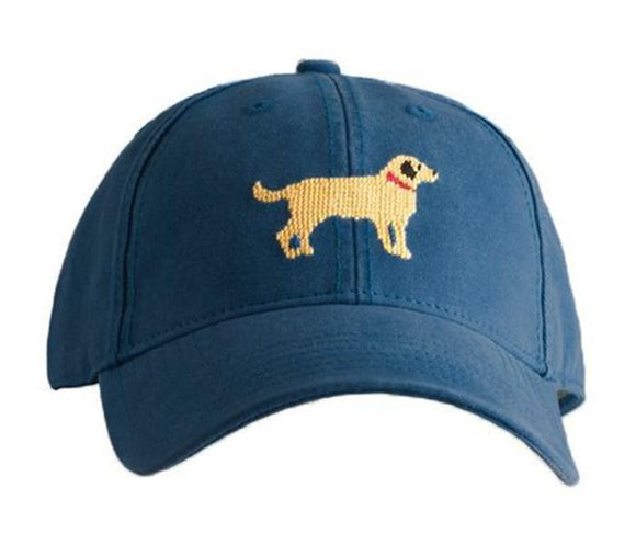 A Handsome Yellow Lab with red color sits on a navy baseball cap waiting for his owner. Great features for a kids needlepoint cap. One size fits ages 4 thru 10 Adjustment in the back.