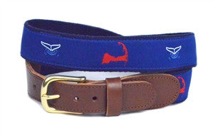 Men's  ribbon belt,  has a red map of Cape cod and white whale tails diving. The images sit on a  on a royal background and is completed with leather tabs and a brass buckle.