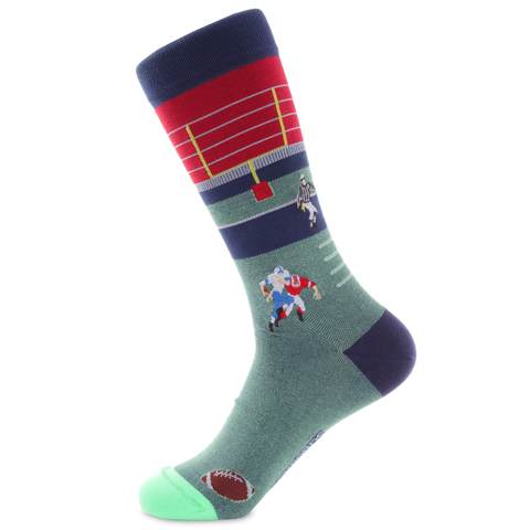 Fotball player and refcomplete the scene witha a gridIron backdrop.A laced up footcal sits at the tow. The nintricate embrodery captures th excitement of the game in colors of red, navy, light blue, and the field of green.